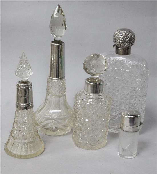 A silver mounted cut glass hip flask and four other silver mounted jars etc.